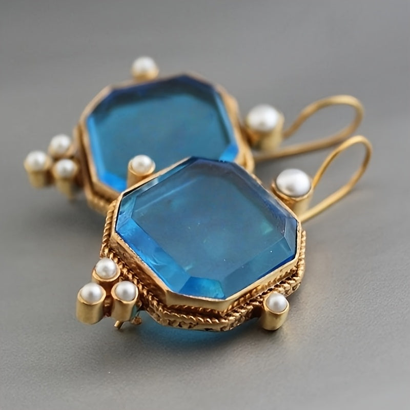 Vintage oorhangers met fleur-de-lis en blauwglazen accenten