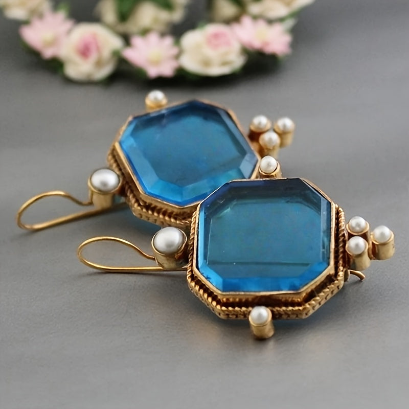 Vintage oorhangers met fleur-de-lis en blauwglazen accenten