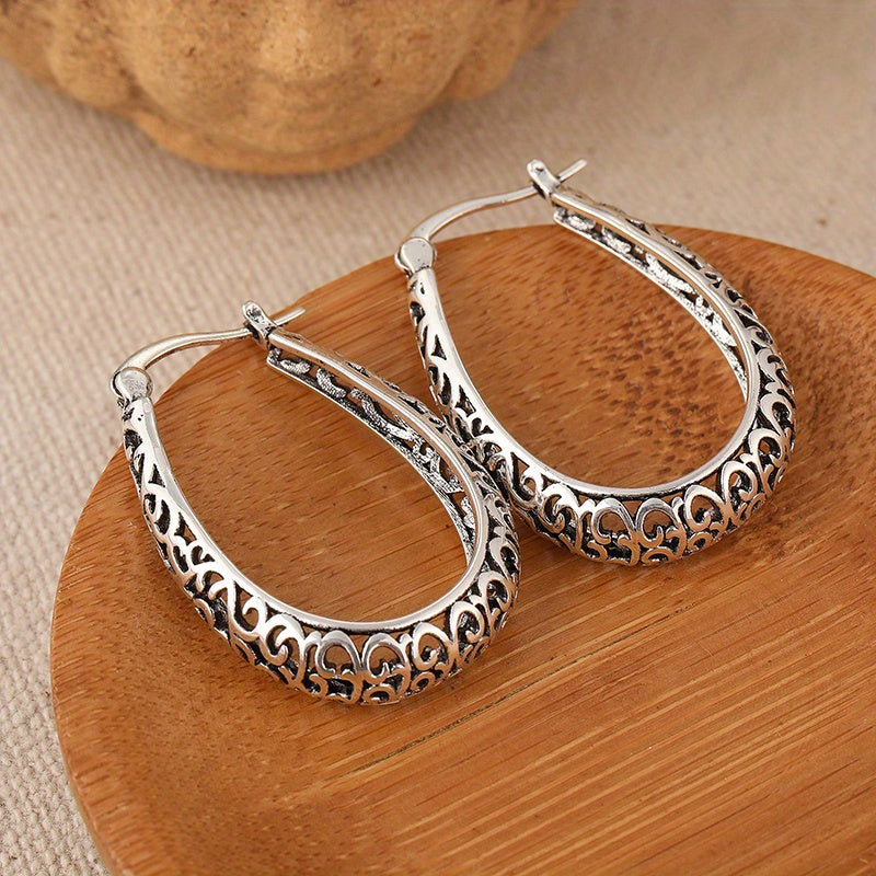 Elegante retro oorringen met krulmotief