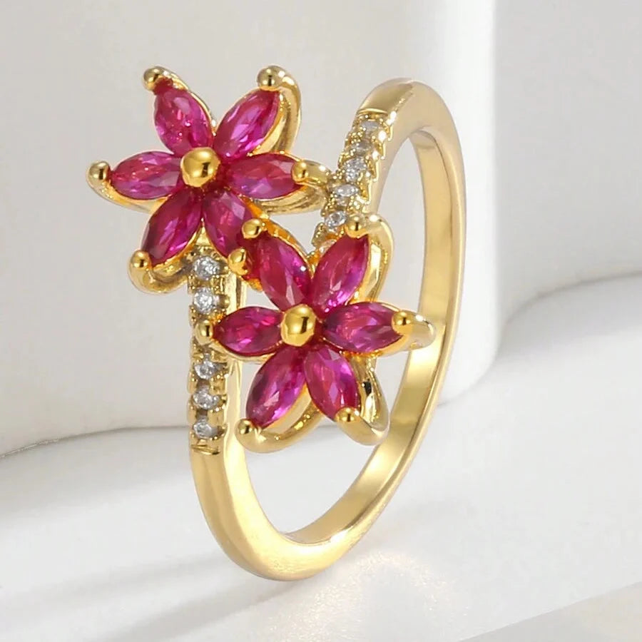 Elegante vintage wikkelring met zirkonia en robijnen bloem
