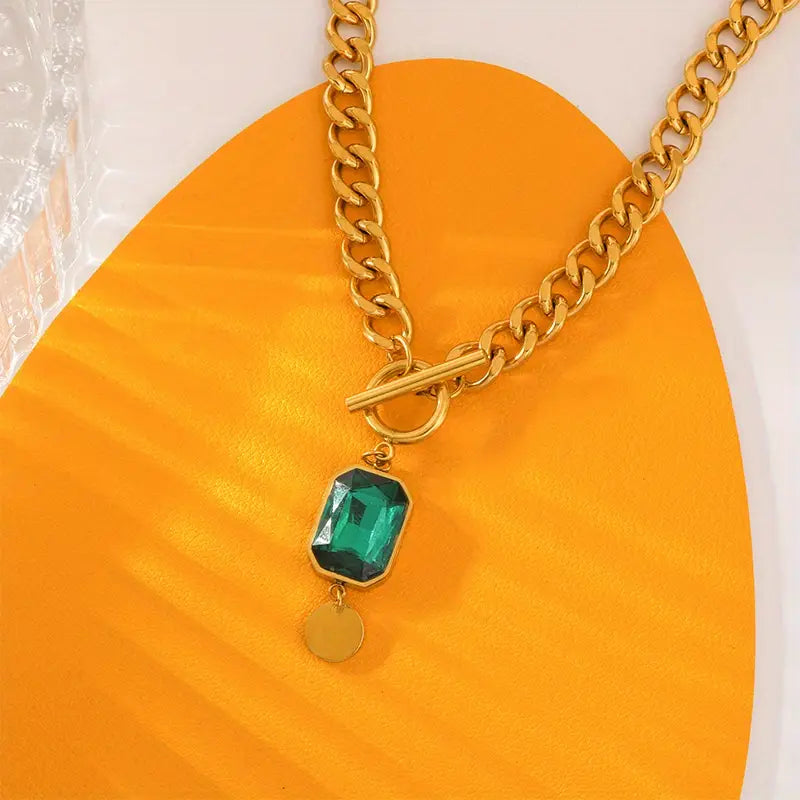 Chunky schakelketting met smaragd hanger | goudkleurig