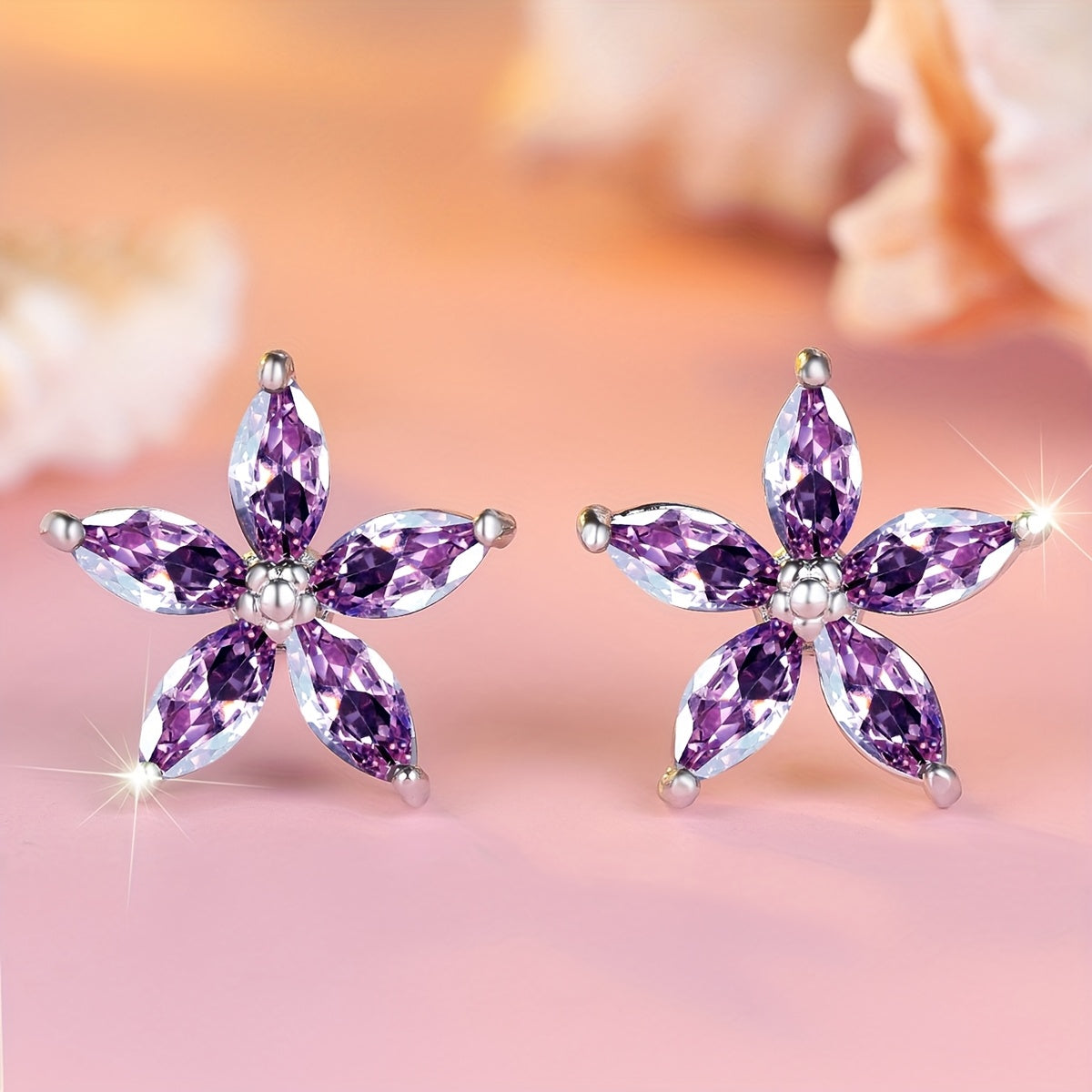 Elegante bloem oorknopjes met paarse zirkonia