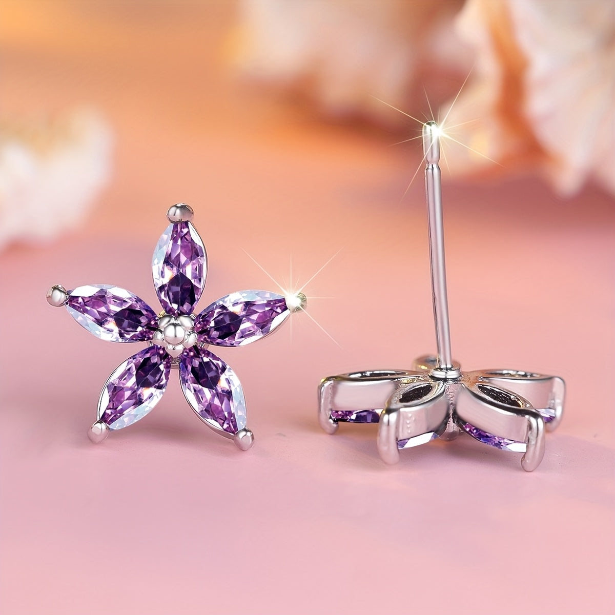 Elegante bloem oorknopjes met paarse zirkonia