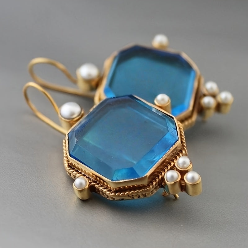 Vintage oorhangers met fleur-de-lis en blauwglazen accenten