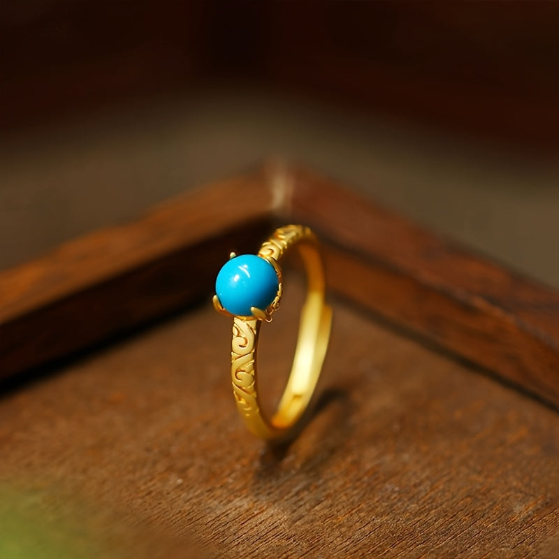 Elegante goudkleurige ring met gladde turkooizen edelsteen