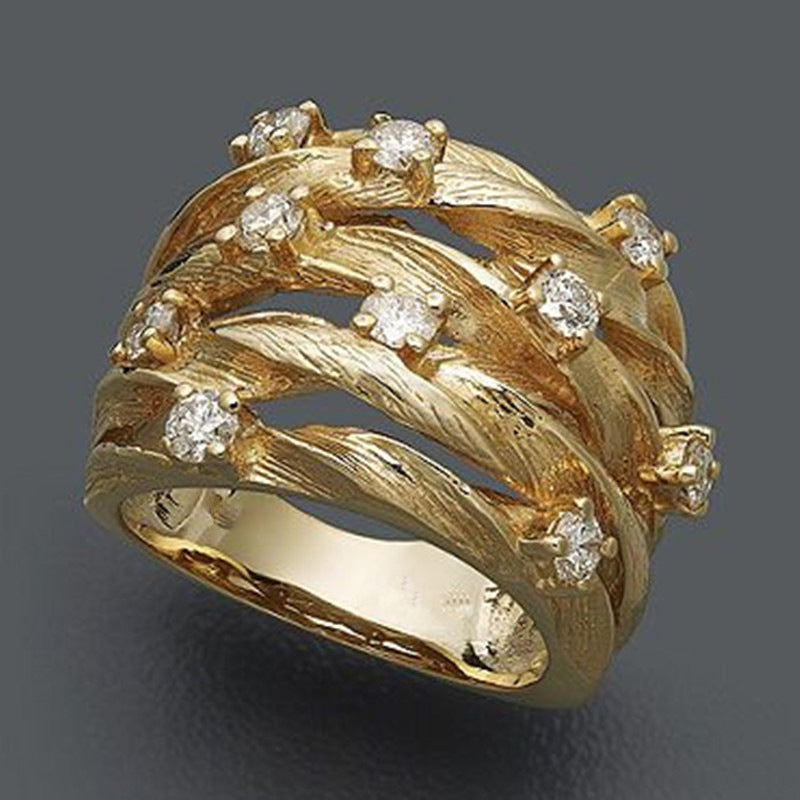 Elegante goudkleurige bandring met kronkelende rank, ster en zirkonia