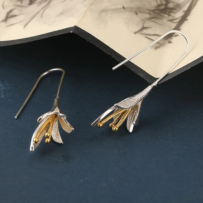 Moderne geborstelde zilverkleurige bloemblad oorhangers