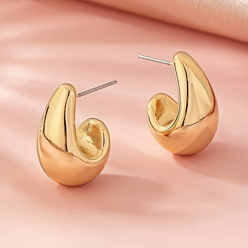 Minimalistische goudkleurige sculpturale C-vormige oorknopjes