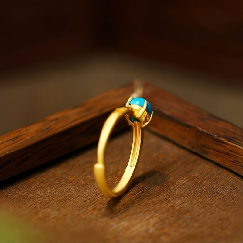 Elegante goudkleurige ring met gladde turkooizen edelsteen