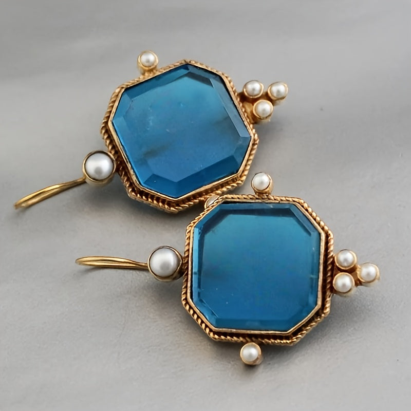 Vintage oorhangers met fleur-de-lis en blauwglazen accenten