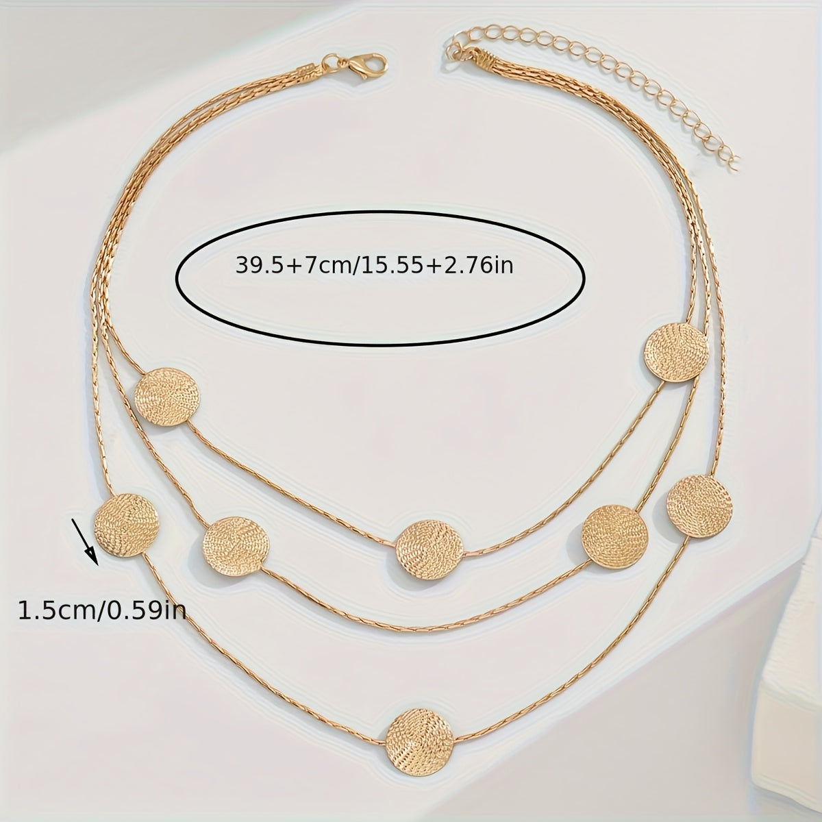 Geometrische goudkleurige gelaagde ketting met spiraalstructuur en meerdere schijven