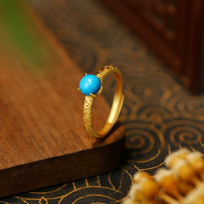 Elegante goudkleurige ring met gladde turkooizen edelsteen