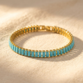 Goudkleurige rechthoekige armband met turkoois inleg