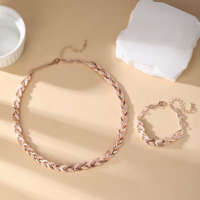 Rosé goudkleurige bladschakel ketting- en armbandset