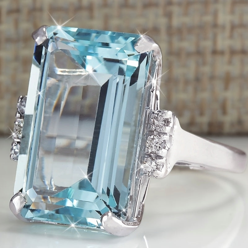 Elegante klassieke ring met vierkante zeeblauwe edelsteen in vier zettingen